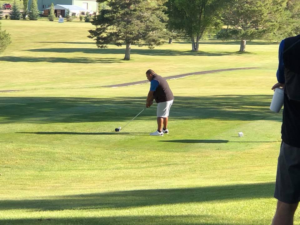 Golfer taking a swing on golf course