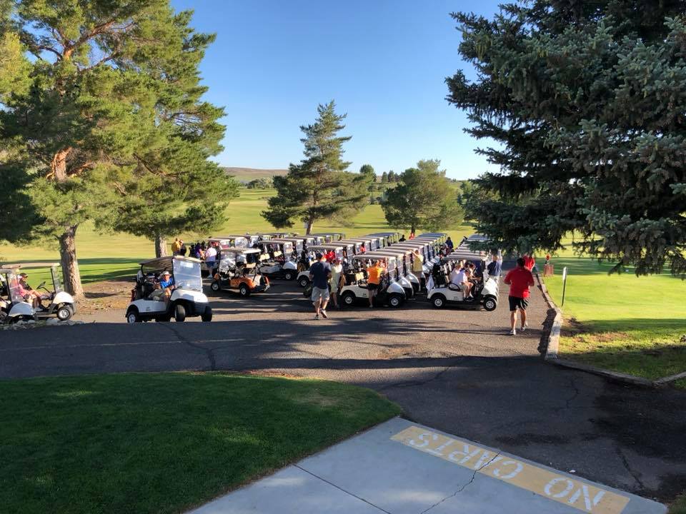 Golf carts and golfers on golf course